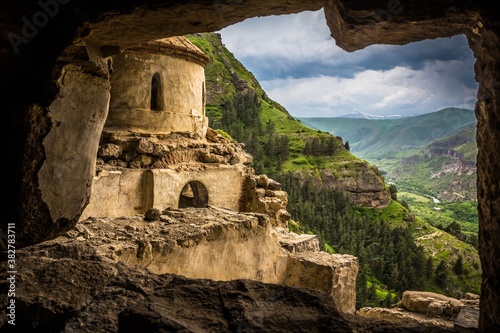 GERGETI, GEORGIA- 3 JUNE 2017. Gorgeous view from Vanis Kvabebi on an old monastery against green valley in the mountains in Samtskhe-Javakheti, Georgia. photo