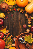 Thanksgiving day concept. Autumn background from fallen leaves and fruits with vintage table setting on old wooden table