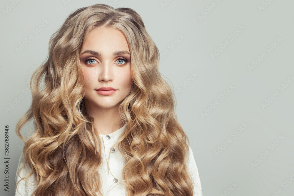 Blonde woman with long healthy curly hairstyle