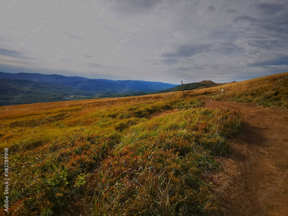 Bieszczady Poland. Carpathians European Mountains. Mountain trails in the Bieszczady Mountains. Autumn colors of the mountains. Cloudy sky.Mountains in autumn.