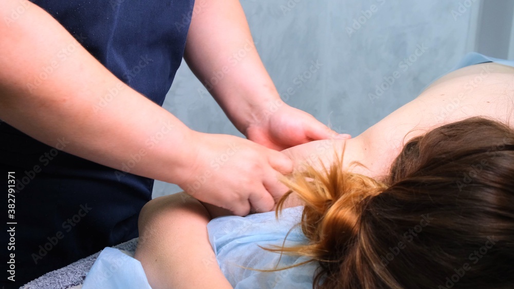 Fototapeta premium Anti-cellulite massage of fat woman's hands in a beauty salon. Perfect beauty concept of burning fat on the skin