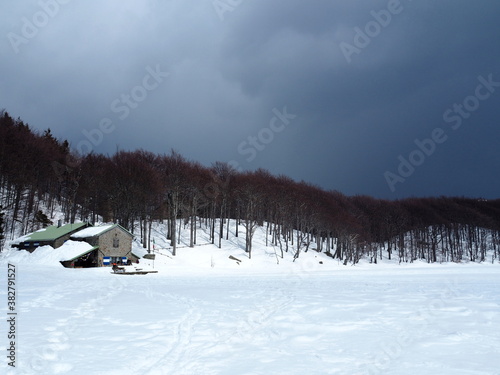 the Mariotti refuge on the Parma holy lake under a stormy sky