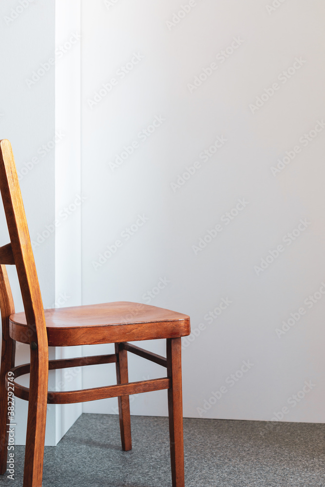 Fototapeta premium wooden chair near wall background