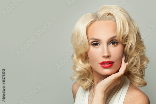 Pretty woman face. Fashion model with blonde curly hairstyle