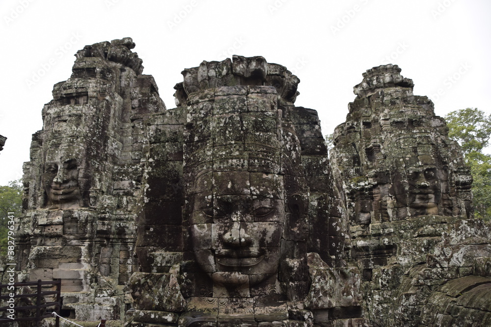 faces carved in stone in a temple in Cambodia
