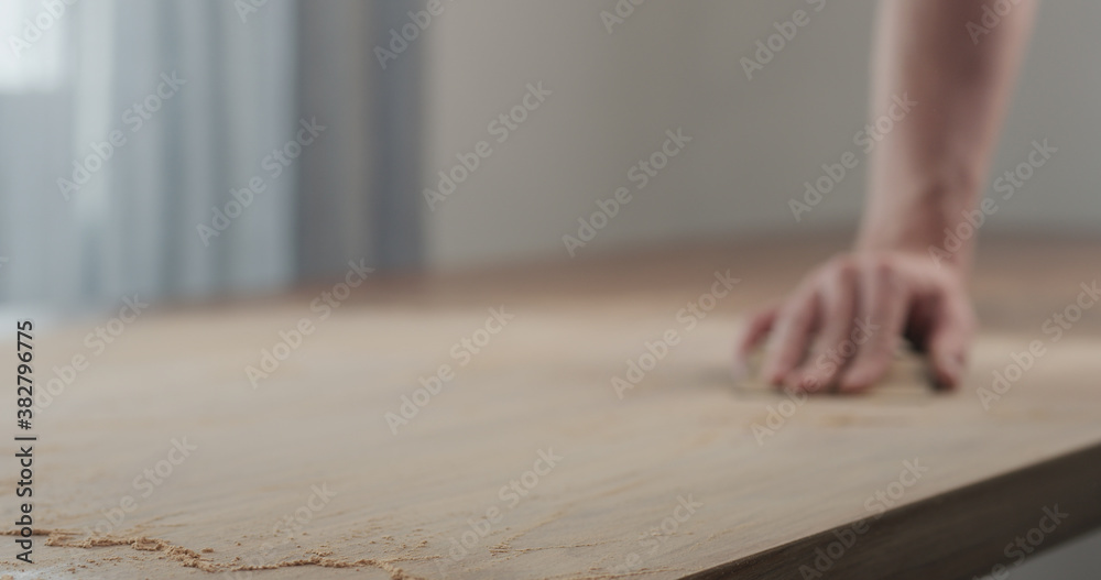 man hand sanding black walnut wood table man hand sanding black walnut wood table