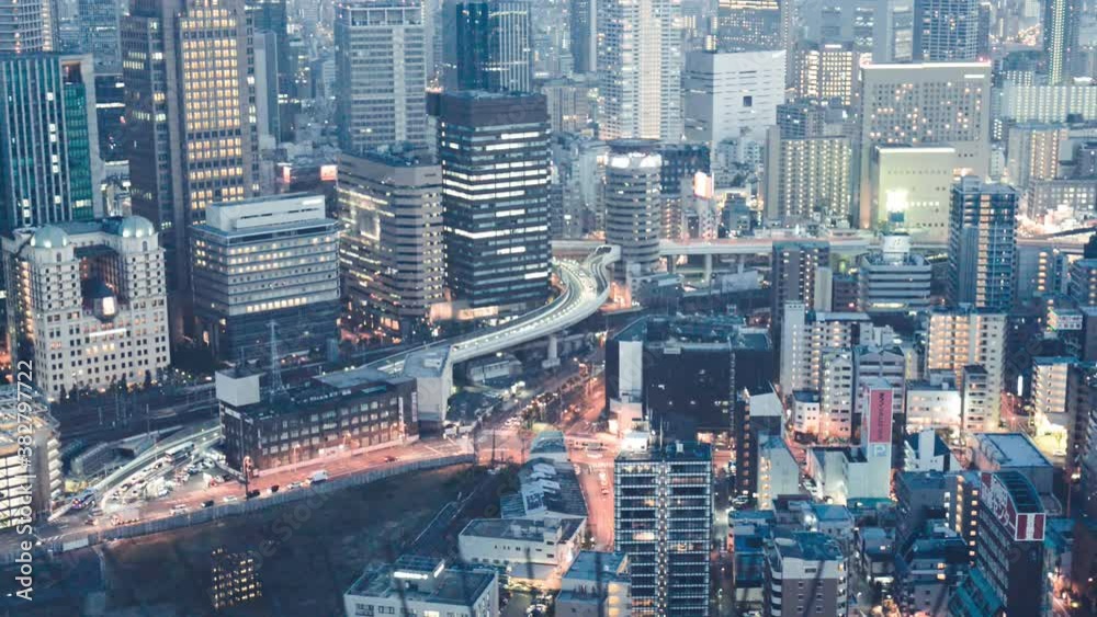 Panoramic view of Osaka city skyline from rooftop at night, Japan. Slow motion Panoramic view of Osaka city skyline from rooftop at night, Japan. Slow motion