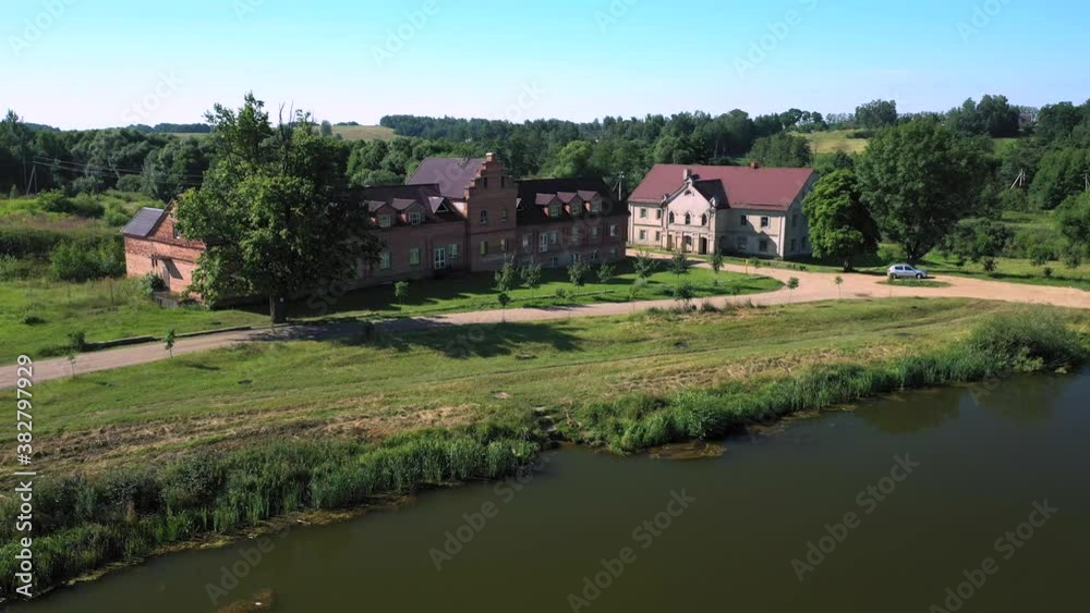 Abandoned house for servants of an old gentry manor in Priluki, Belarus. Sunset reflection in calm water. Historic buildings in Priluki town.
Abandoned house for servants of an old gentry manor in Priluki, Belarus. Sunset reflection in calm water. Historic buildings in Priluki town.