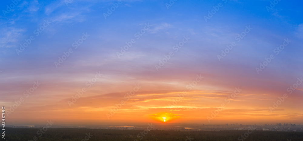 Yellow blue orange morning sky sunrise. Panorama.
