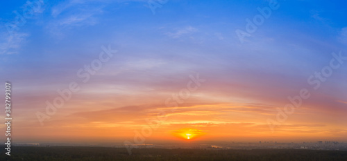 Yellow blue orange morning sky sunrise. Panorama.