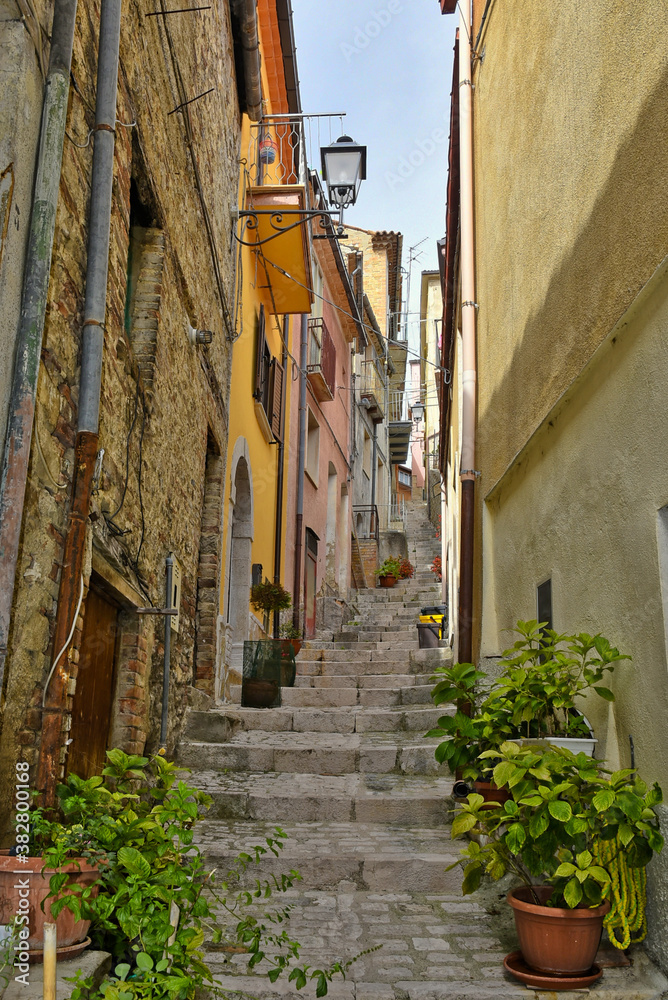 A narrow street among the old houses of Mirabello Sannitico, a medieval village in the province of Campobasso, Italy