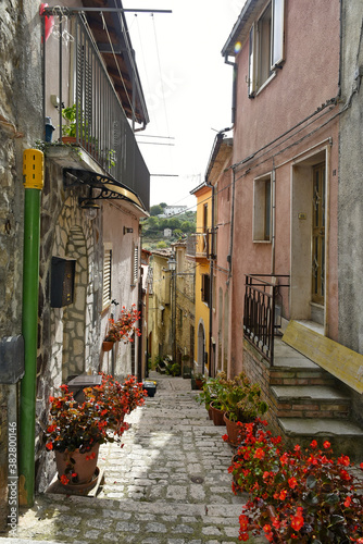Fototapeta Naklejka Na Ścianę i Meble -  A narrow street among the old houses of Mirabello Sannitico, a medieval village in the province of Campobasso, Italy