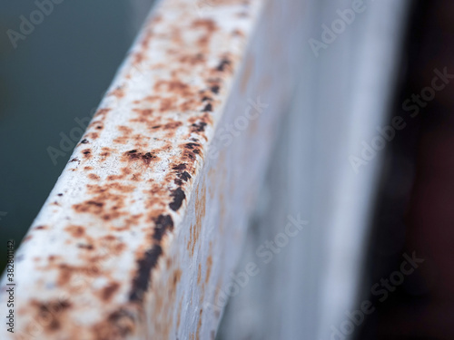 Rust and corrosion in the fence bar and metal skin