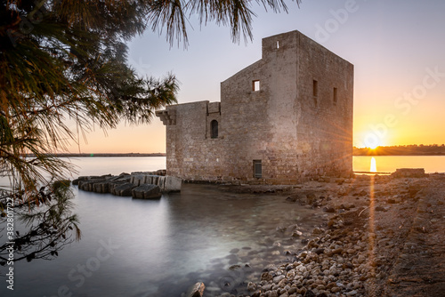 Shot of the ruins of the Torre Sveva at the Tonnara of Vendicari at sunset. The building was used as tuna-fishing nets and it's now part of a beautiful protected natural reserve photo