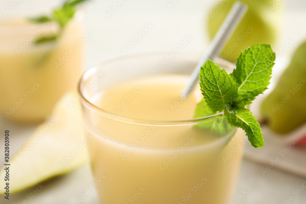 Tasty pear juice with mint in glass, closeup