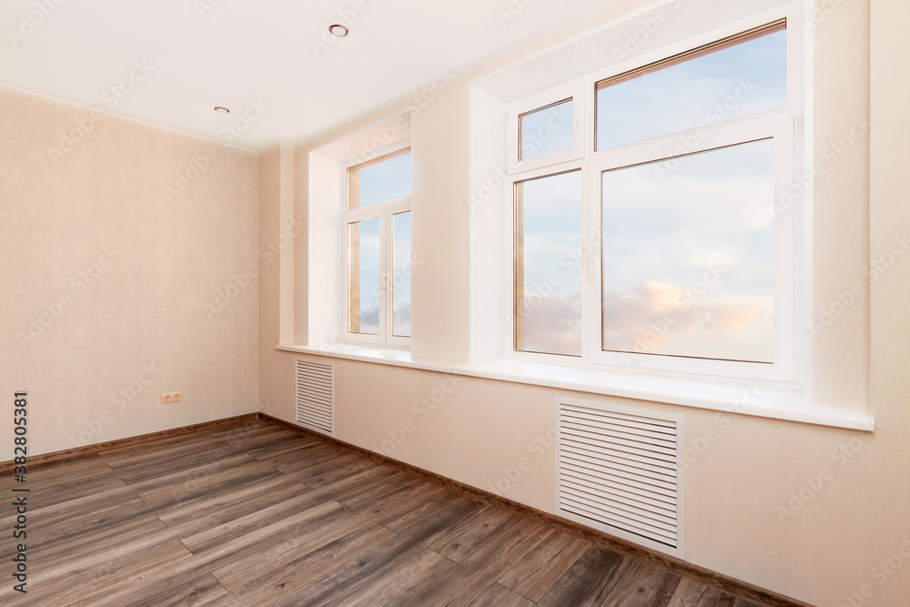 Fototapeta premium White empty room with two windows and wooden floor. Loft interior mock up. 3d render home blank space.