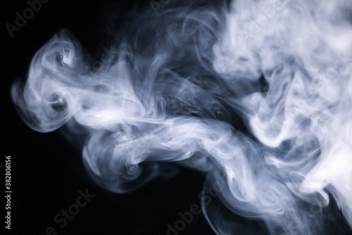 White cigarette smoke texture in a black background. 
