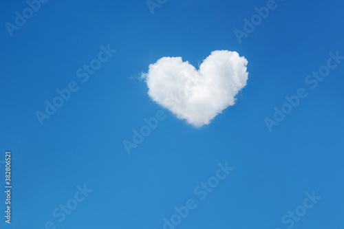 One lonely cloud in the shape of a heart in the bright blue sky