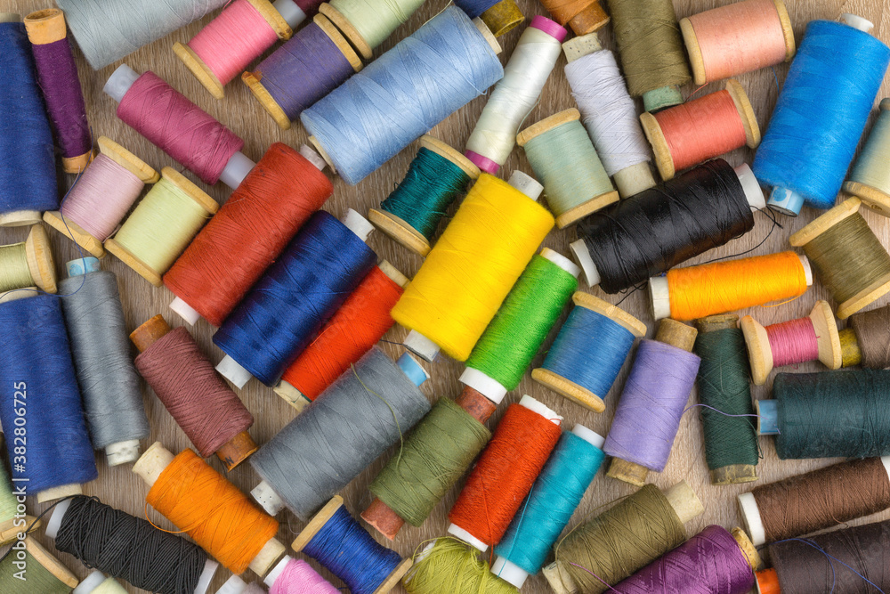 Many spools of multicolored threads as a background, texture, pattern. Many spools of multicolored threads as a background, texture, pattern.
