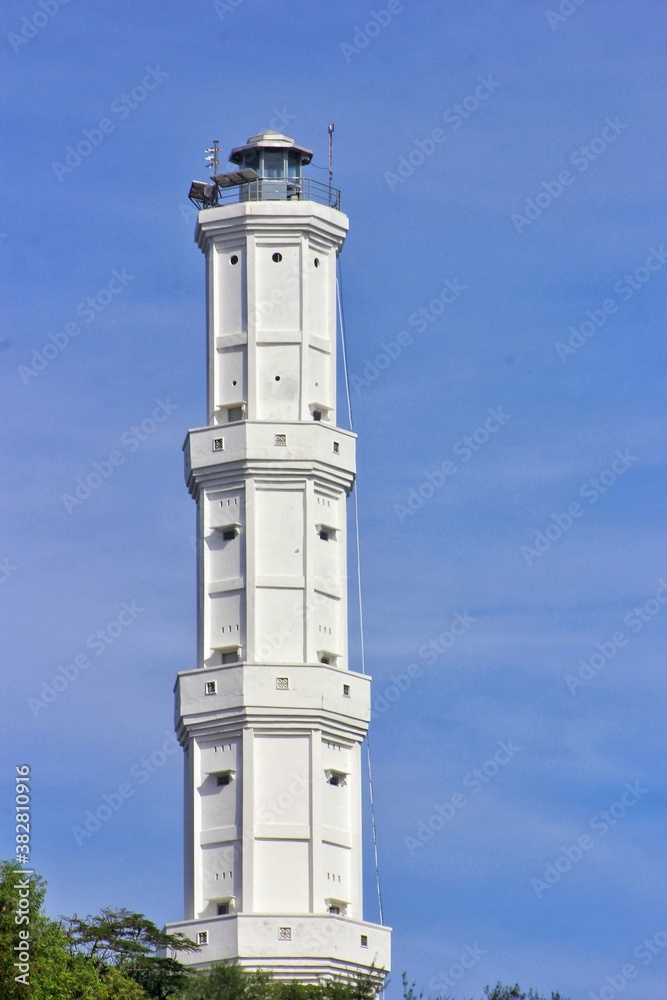 lighthouse on the island of island baron beach, bantul central java - indonesia