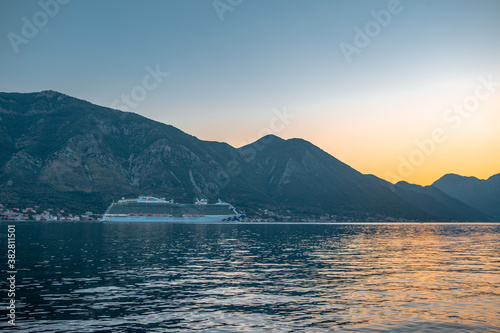 Sunset view of Kotor Bay in Montenegro, with mountains and sea.
