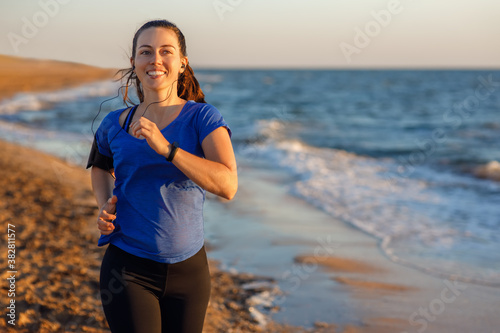 Fototapeta Naklejka Na Ścianę i Meble -  Fitness woman running on the beach