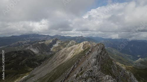 Mountain Ridge in the Summit of a Peak in Somiedo Natural Park, Asturias, Spain. Aerial 4k cinematic drone footage. Hiking Route During Cloudy Day. photo