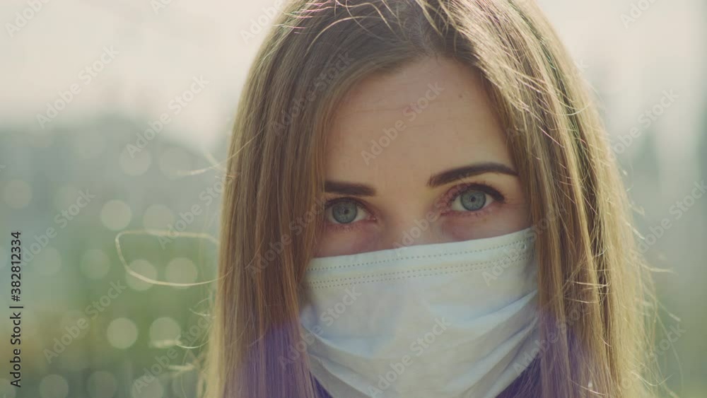 Woman wearing protective mask on street. Portrait. Red Helium with Carl Zeiss CP.2. Woman wearing protective mask on street. Portrait. Red Helium with Carl Zeiss CP.2.