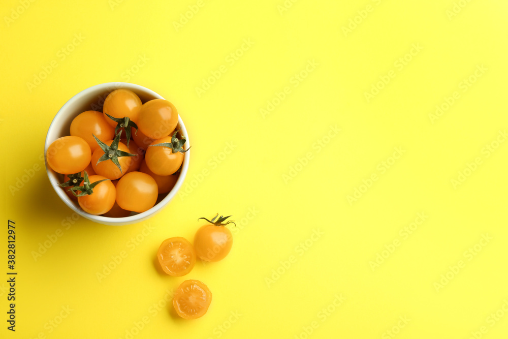Yellow tomatoes on color background, flat lay. Space for text Yellow tomatoes on color background, flat lay. Space for text