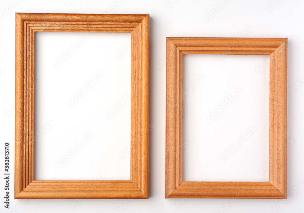 two vertical wooden frames on white background with shadow.
two vertical wooden frames on white background with shadow.