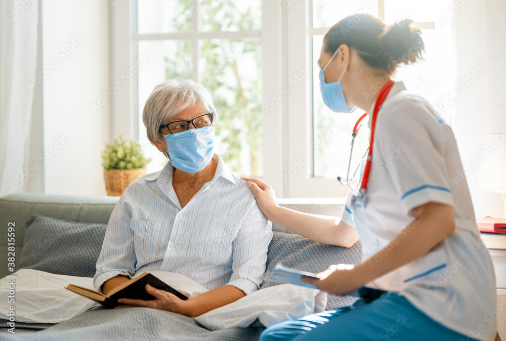 Fototapeta premium Doctor and senior woman wearing facemasks