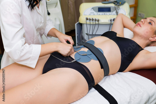 Myostimulation of abdominal muscles for weight loss.