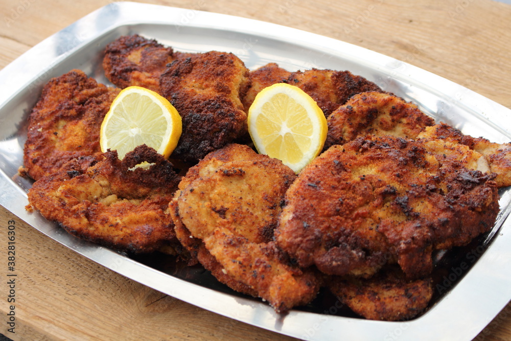 lots of crispy fried Viennese schnitzel with lemon lots of crispy fried Viennese schnitzel with lemon