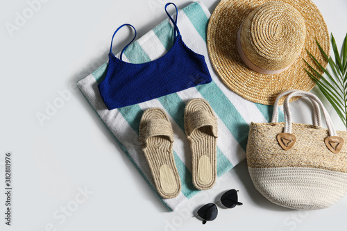 Composition with stylish beach accessories on white background, top view