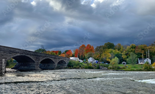 Pakenham Bridge, a five arch stone bridge that crosses the Mississippi River on a stormy autumn day in Pakenham, Canada photo