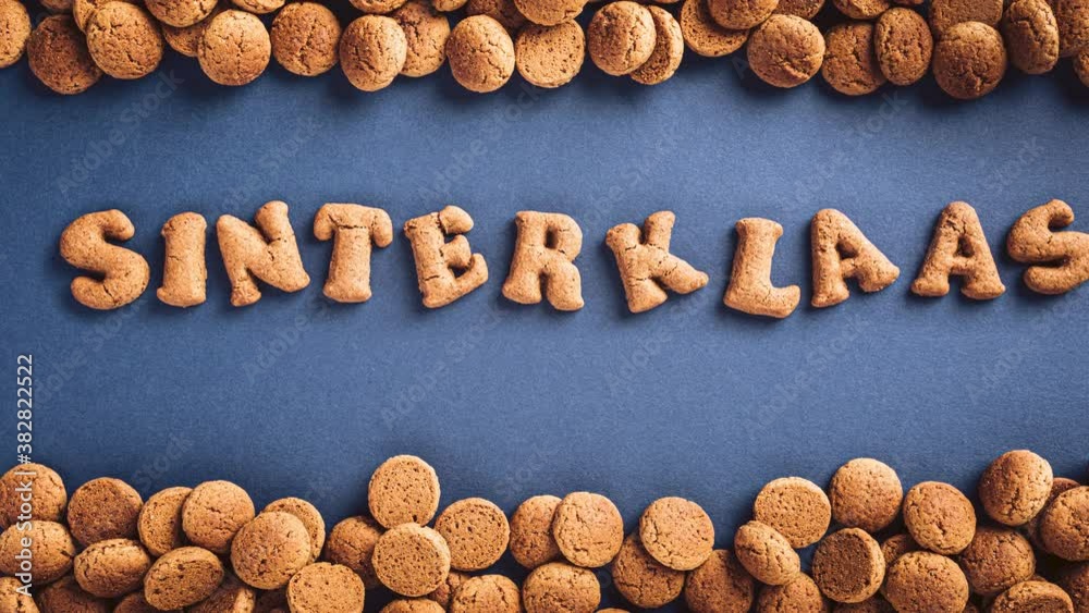 Stop motion animation. Sinterklaas is coming soon, 4K. Dutch holiday St Nicholas day concept with letters traditional cookies, kruidnoten on blue background with copy space. Top view.