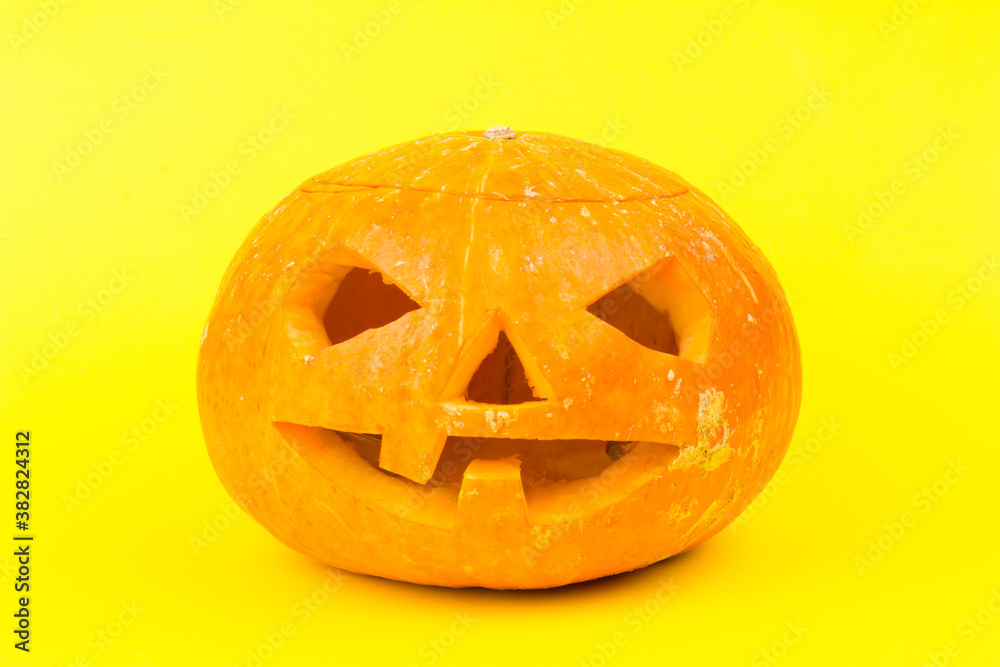 Glowing Halloween Pumpkin isolated on yellow background Glowing Halloween Pumpkin isolated on yellow background