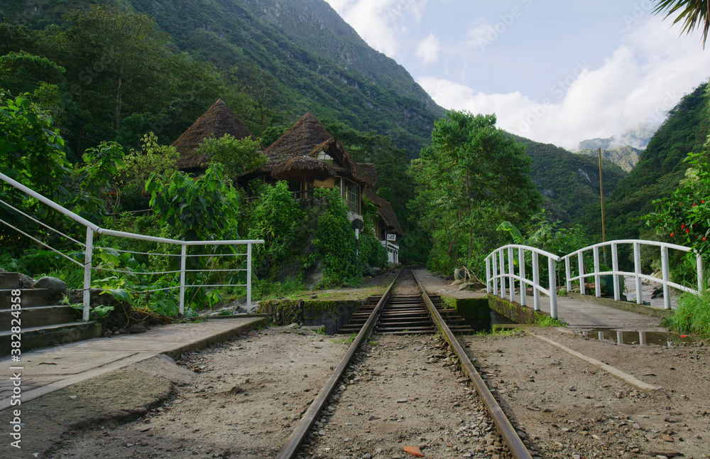 A track leading to a mountain village through a canyon