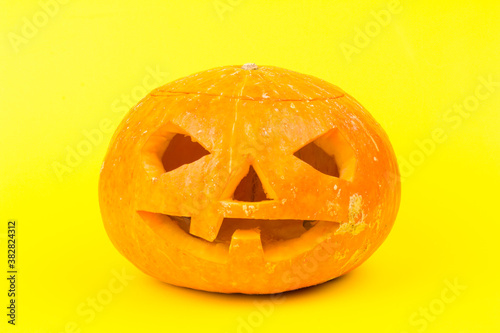 Glowing Halloween Pumpkin isolated on yellow background