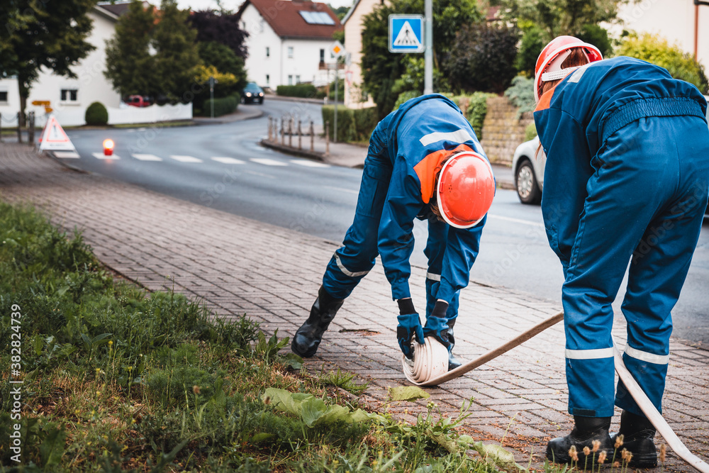 Jugendfeuerwehr rollt nach der Übung Schläuche zusammen Jugendfeuerwehr rollt nach der Übung Schläuche zusammen