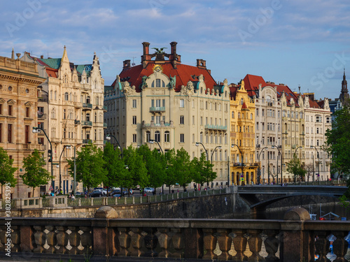 Historic houce facades on Smetana riverfront in Prague at the sunset