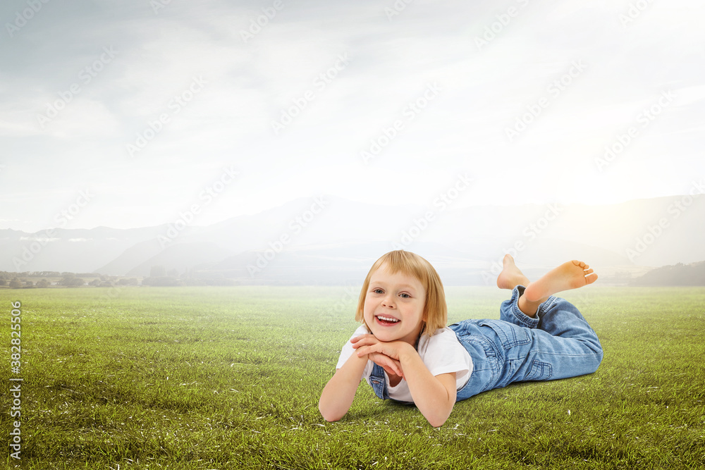 Little girl on the green grass