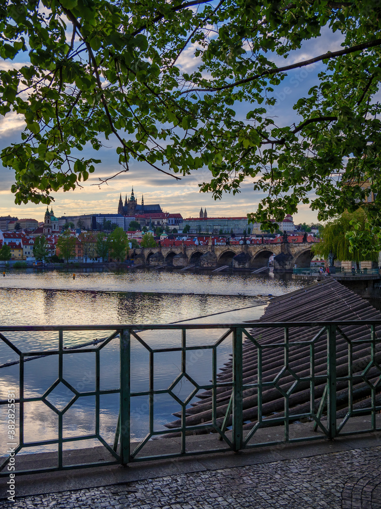 View on the St. Vitus Cathedral in Prague's Castle from the Old Town across Vltava river at the sunset