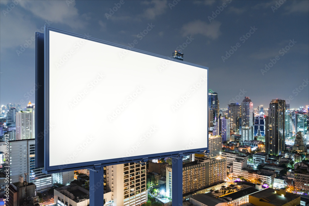 Blank white road billboard with Bangkok cityscape background at night time. Street advertising poster, mock up, 3D rendering. Side view. The concept of marketing communication to sell idea. Blank white road billboard with Bangkok cityscape background at night time. Street advertising poster, mock up, 3D rendering. Side view. The concept of marketing communication to sell idea.