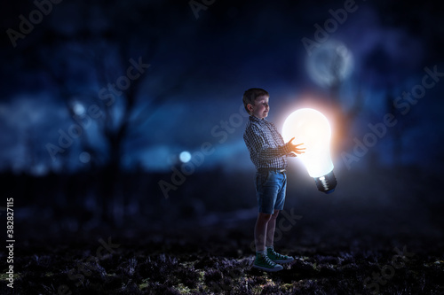 Boy with a light bulb © Sergey Nivens