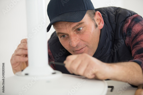 concentrated man in fixing a chair