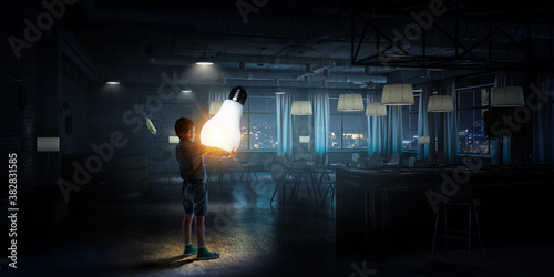 Boy holding a light bulb