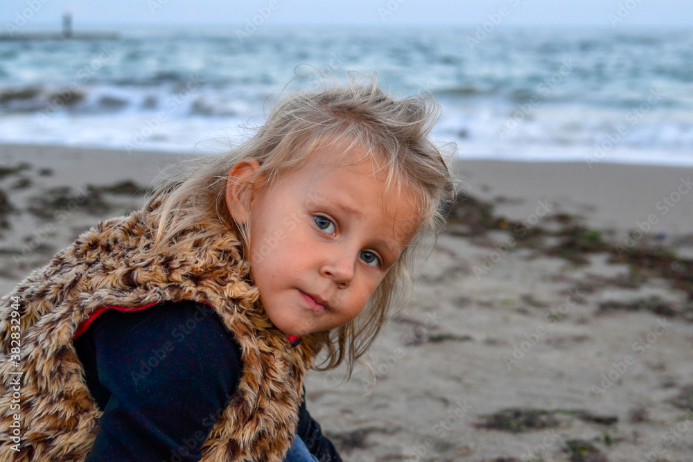 Child portrait. Girl outdoors at sea or ocean. Beautiful girl 3 years old. Autumn photo. Child portrait. Girl outdoors at sea or ocean. Beautiful girl 3 years old. Autumn photo.