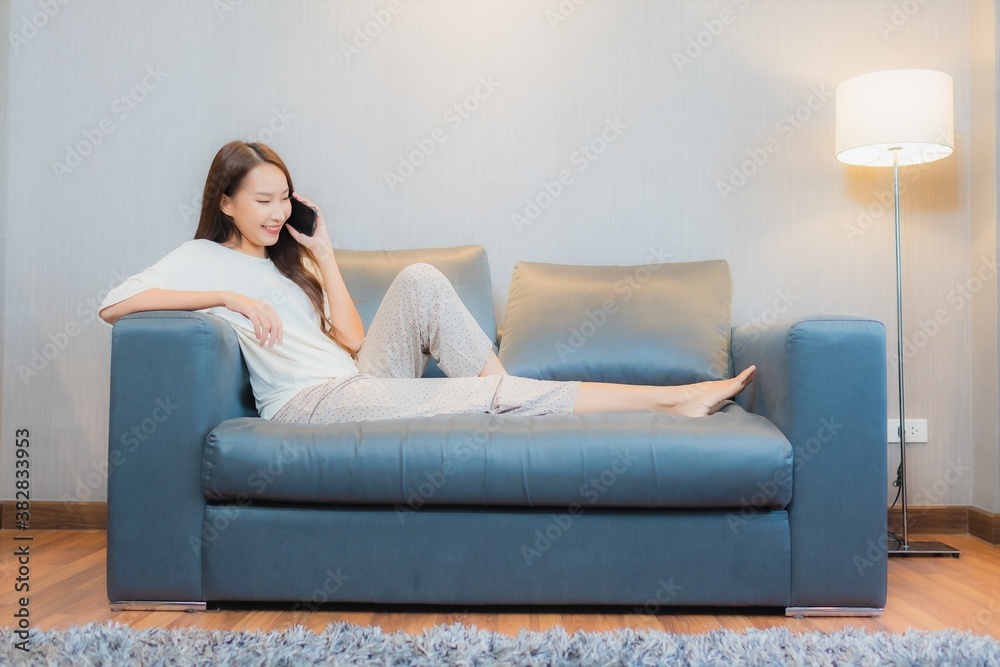 Portrait beautiful young asian woman use smart mobile phone on sofa Portrait beautiful young asian woman use smart mobile phone on sofa