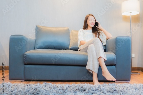 Portrait beautiful young asian woman use smart mobile phone on sofa